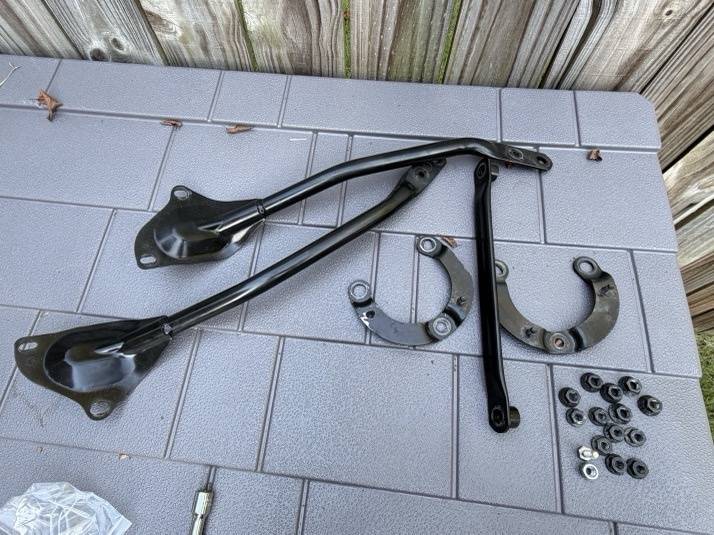 Strut brace and hardware laid out before install